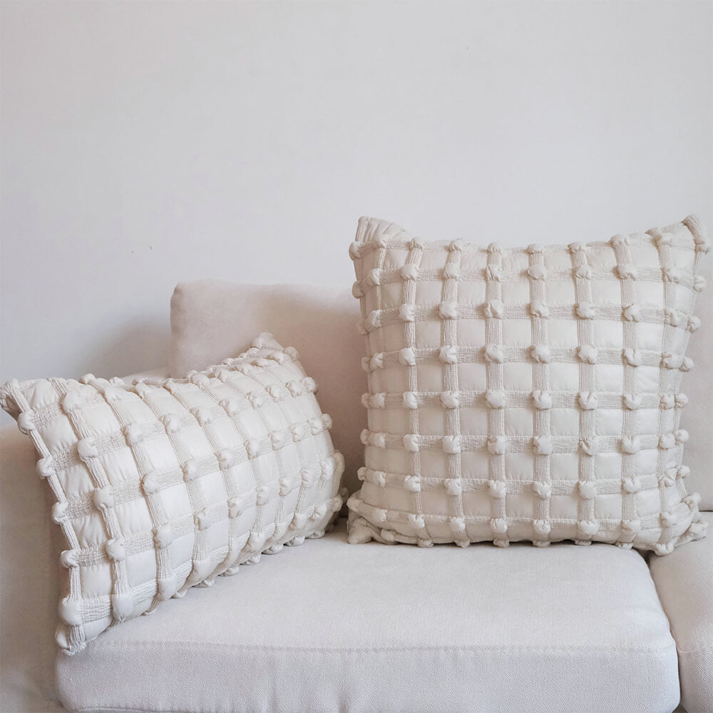Luxury decorative checkered cushion for lumbar support on sofa at home.